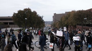 Students march along the University Place Promenade during the Sanctuary Campus walk out.